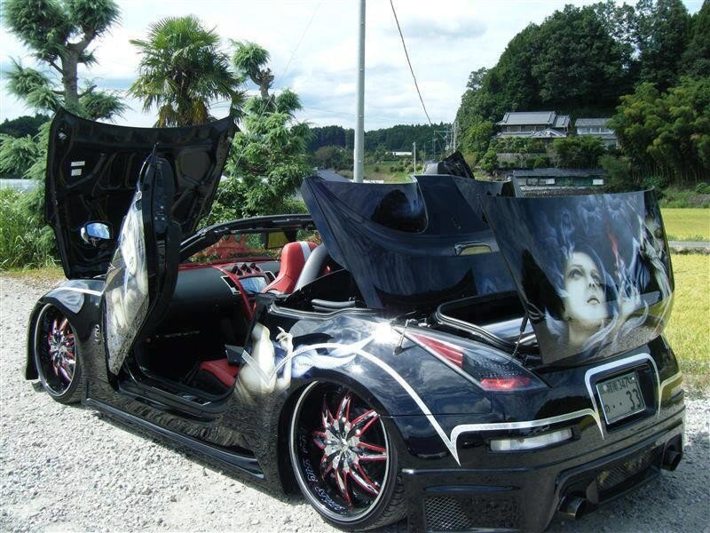 Custom black sports car with artwork