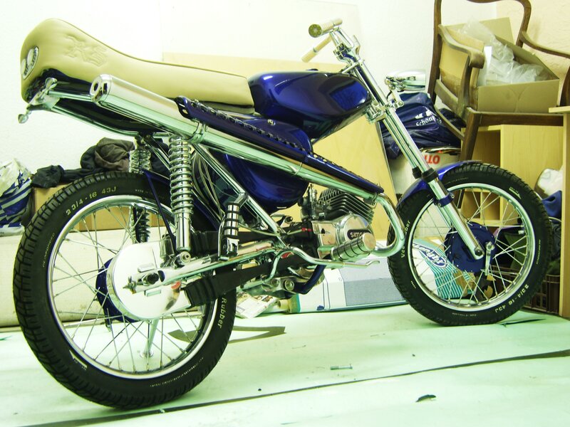 Custom blue motorcycle in workshop