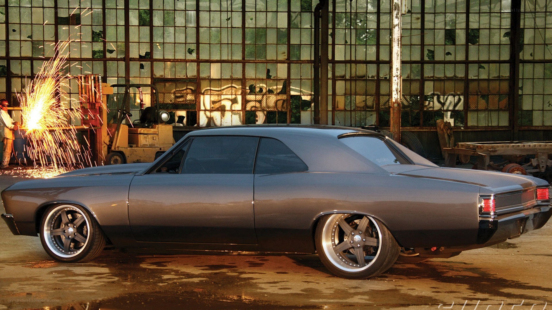 Custom car in workshop with sparks