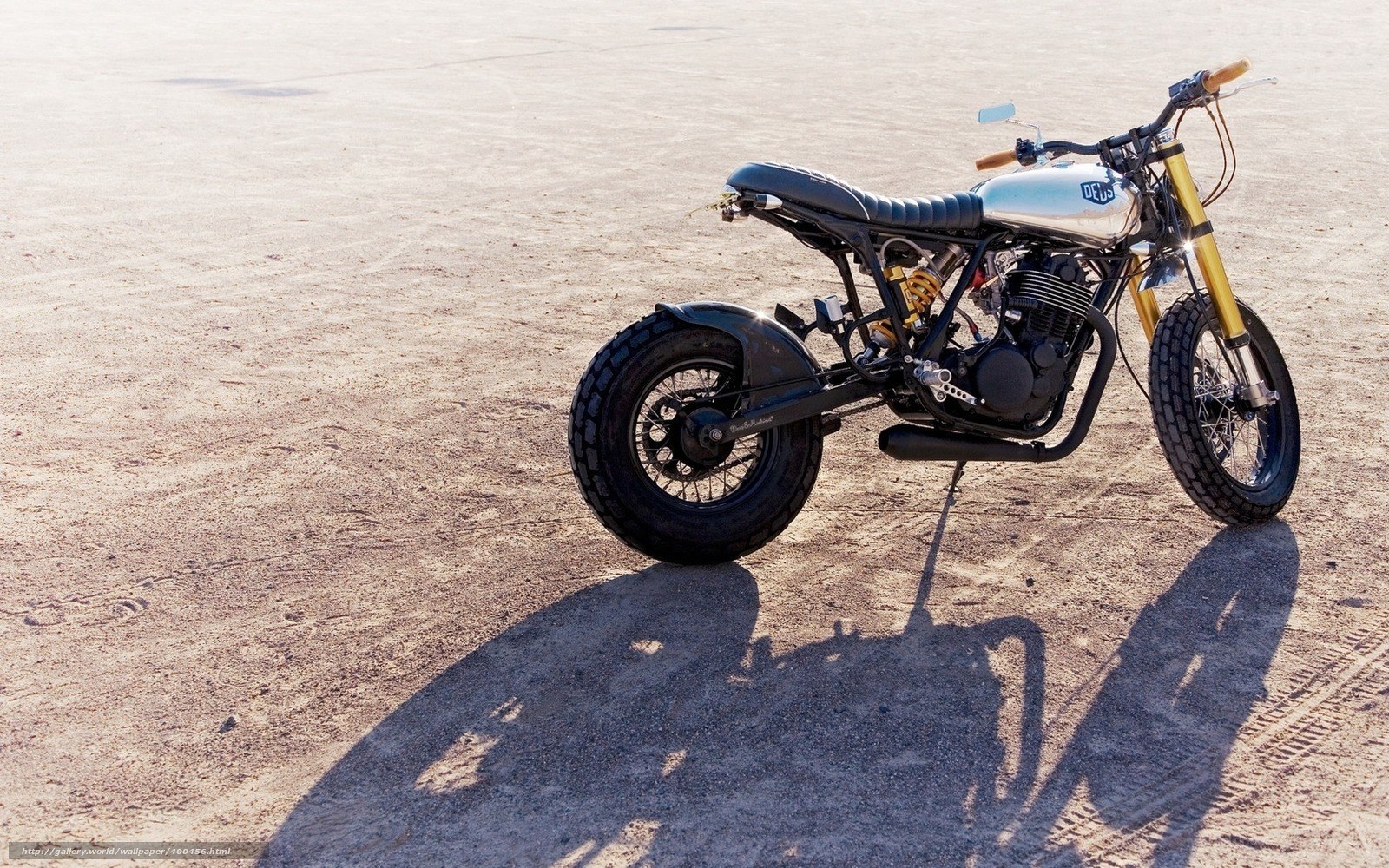 custom motorcycle on desert sand