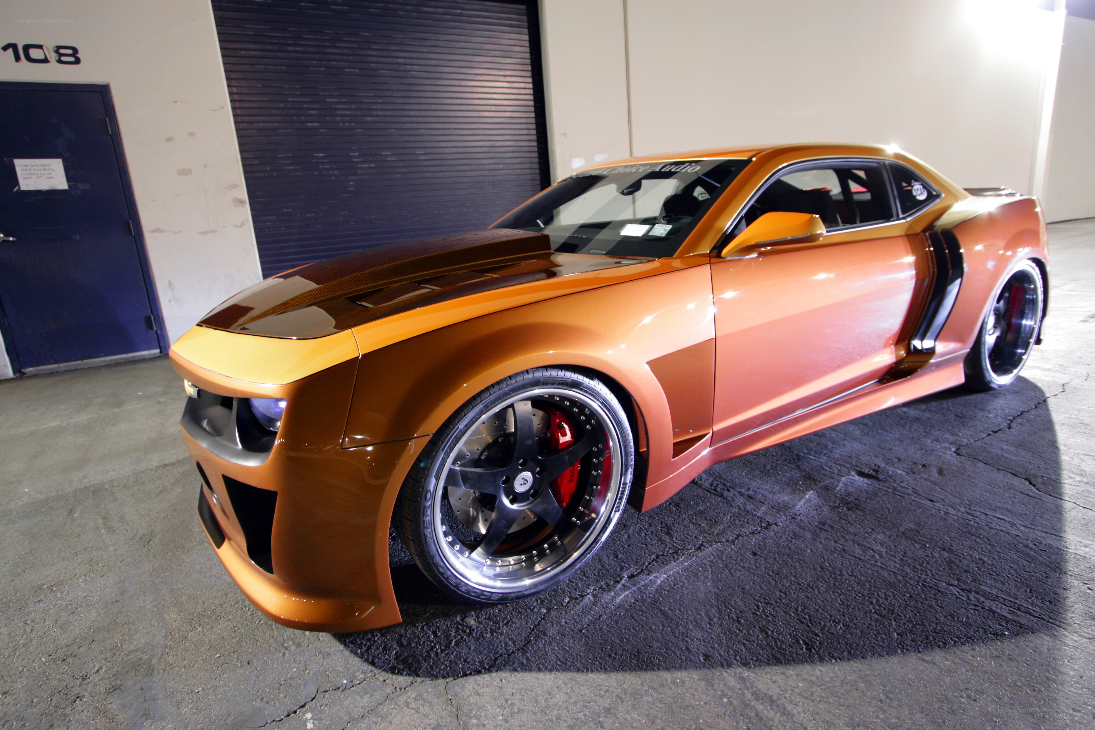 Custom orange Camaro in garage