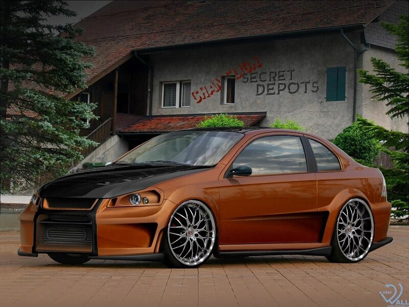 Custom orange coupe in front of building