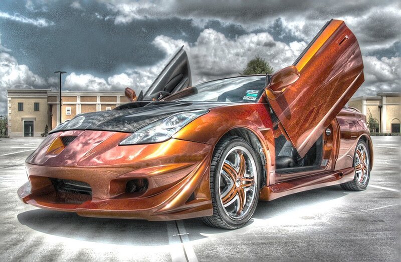 Custom orange sports car with gullwing doors