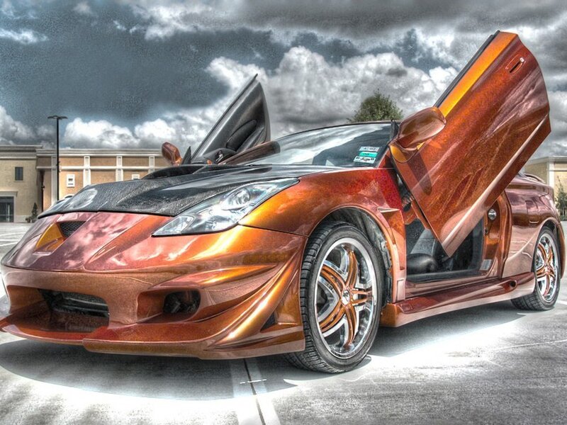 Custom orange sports car with gullwing doors