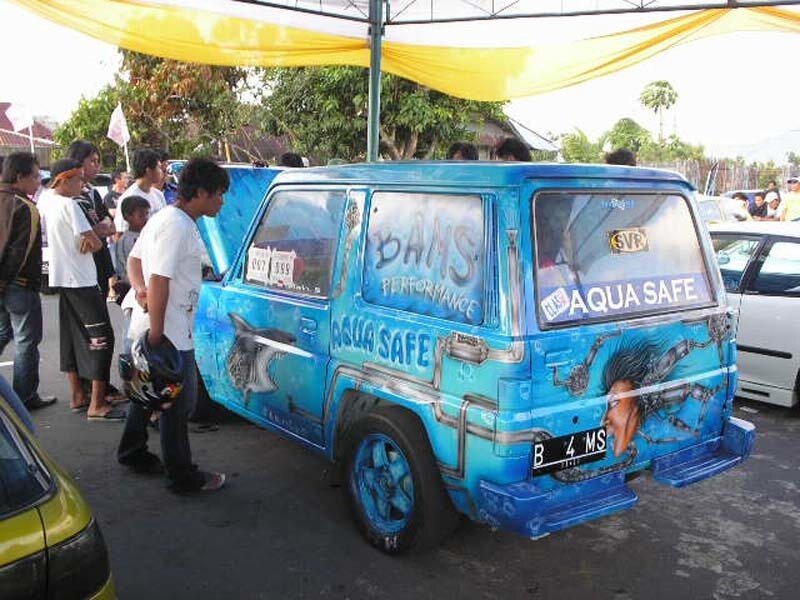 Custom-painted blue van at outdoor event