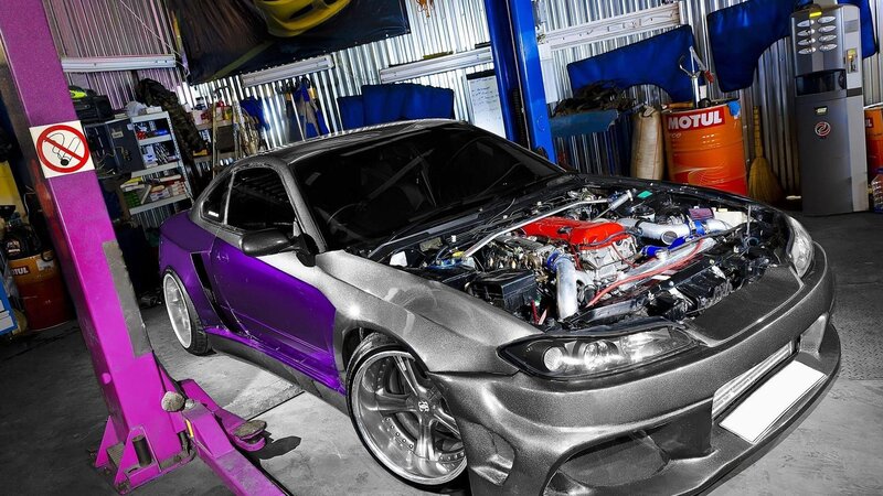Custom purple and silver car in garage