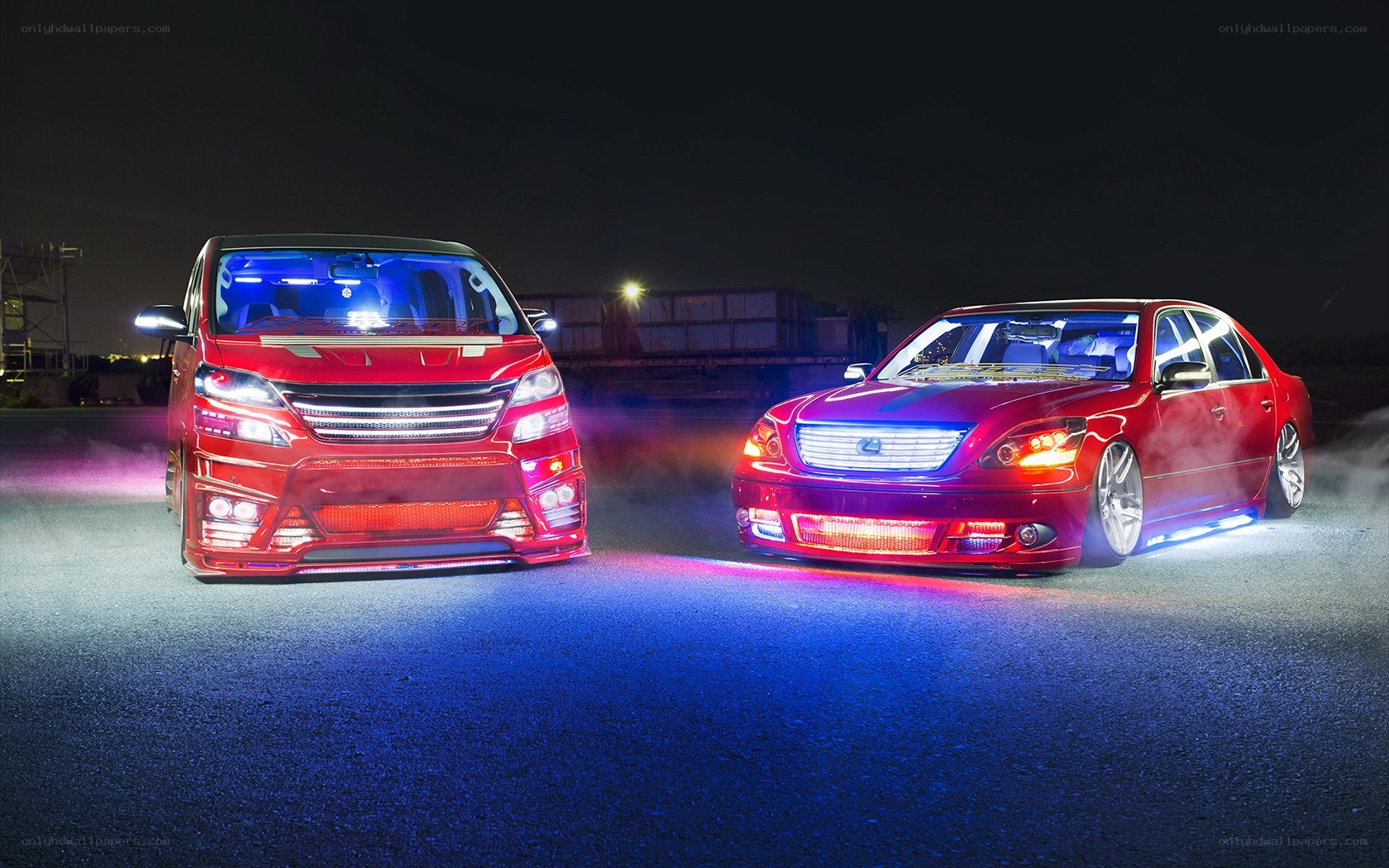 Custom red cars at night