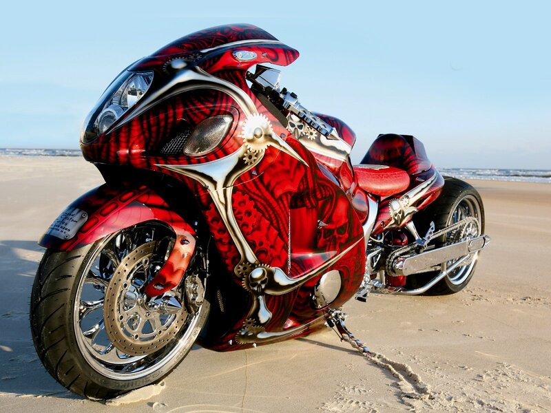 custom red motorcycle on beach