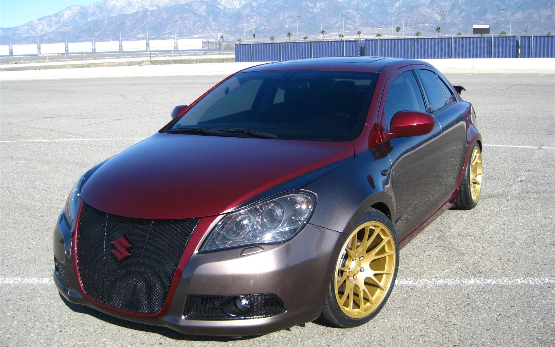 custom suzuki car with gold wheels