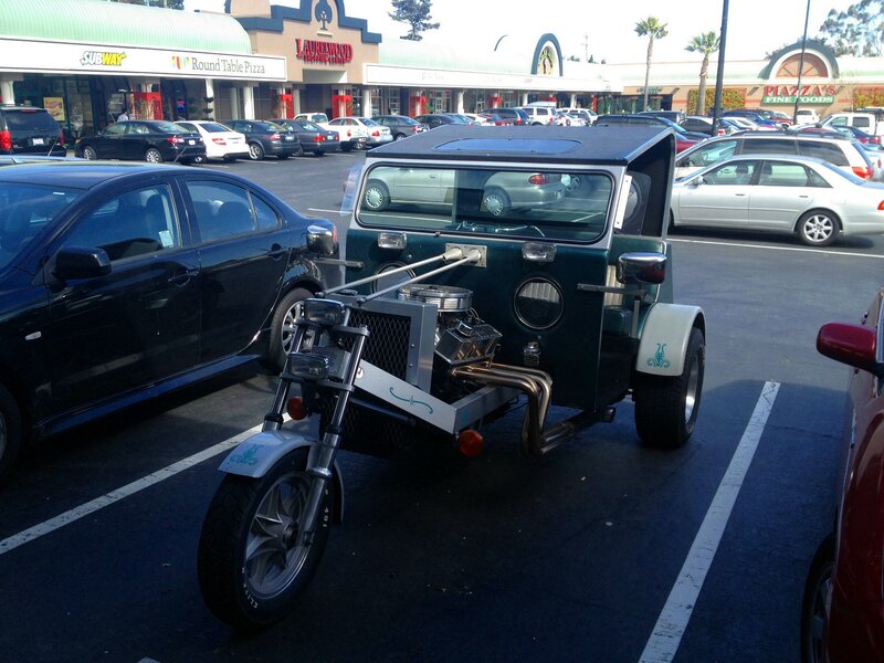 Custom three-wheeled vehicle in parking lot
