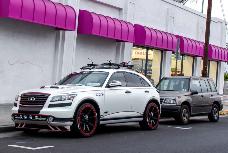 Custom white Infiniti parked on street