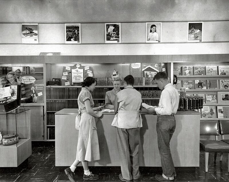 Customers at a record store counter