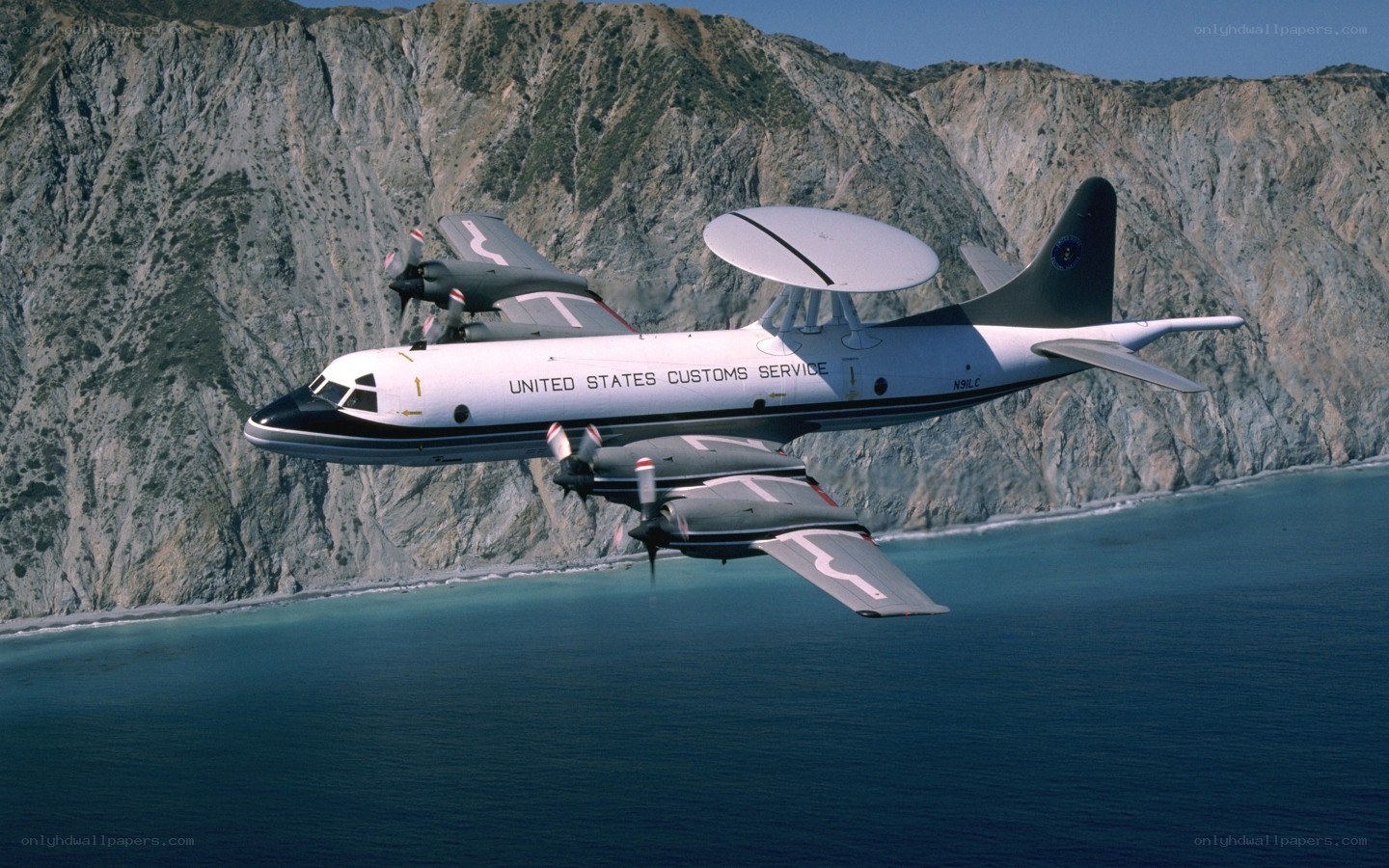 Customs aircraft over coastline