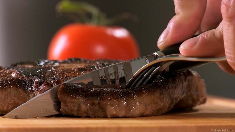 cutting a grilled steak