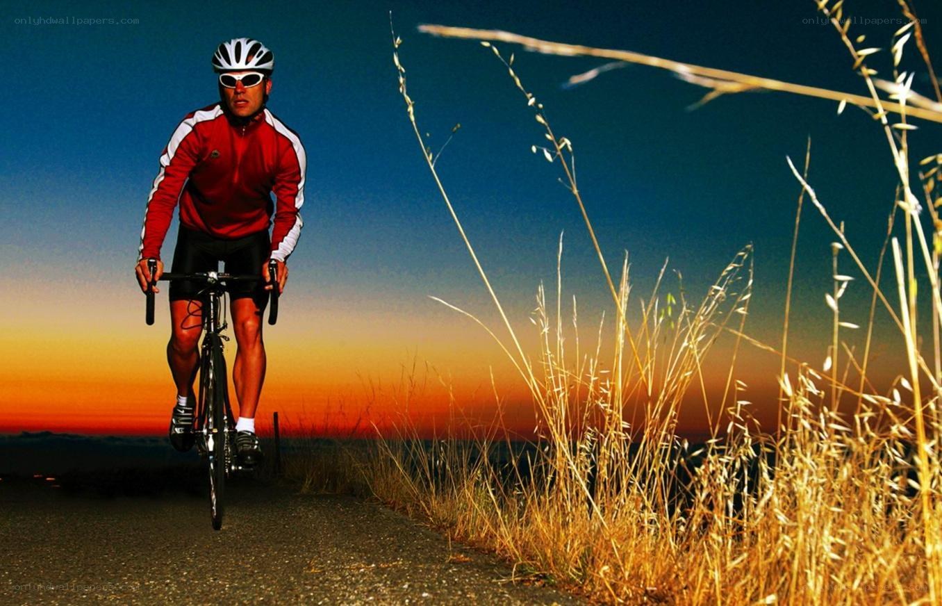 cyclist at sunset on a road