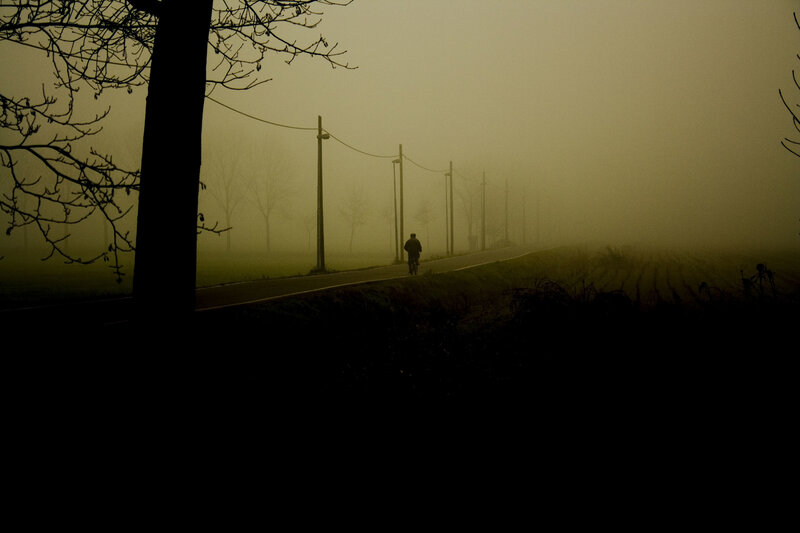 Cyclist in a foggy landscape