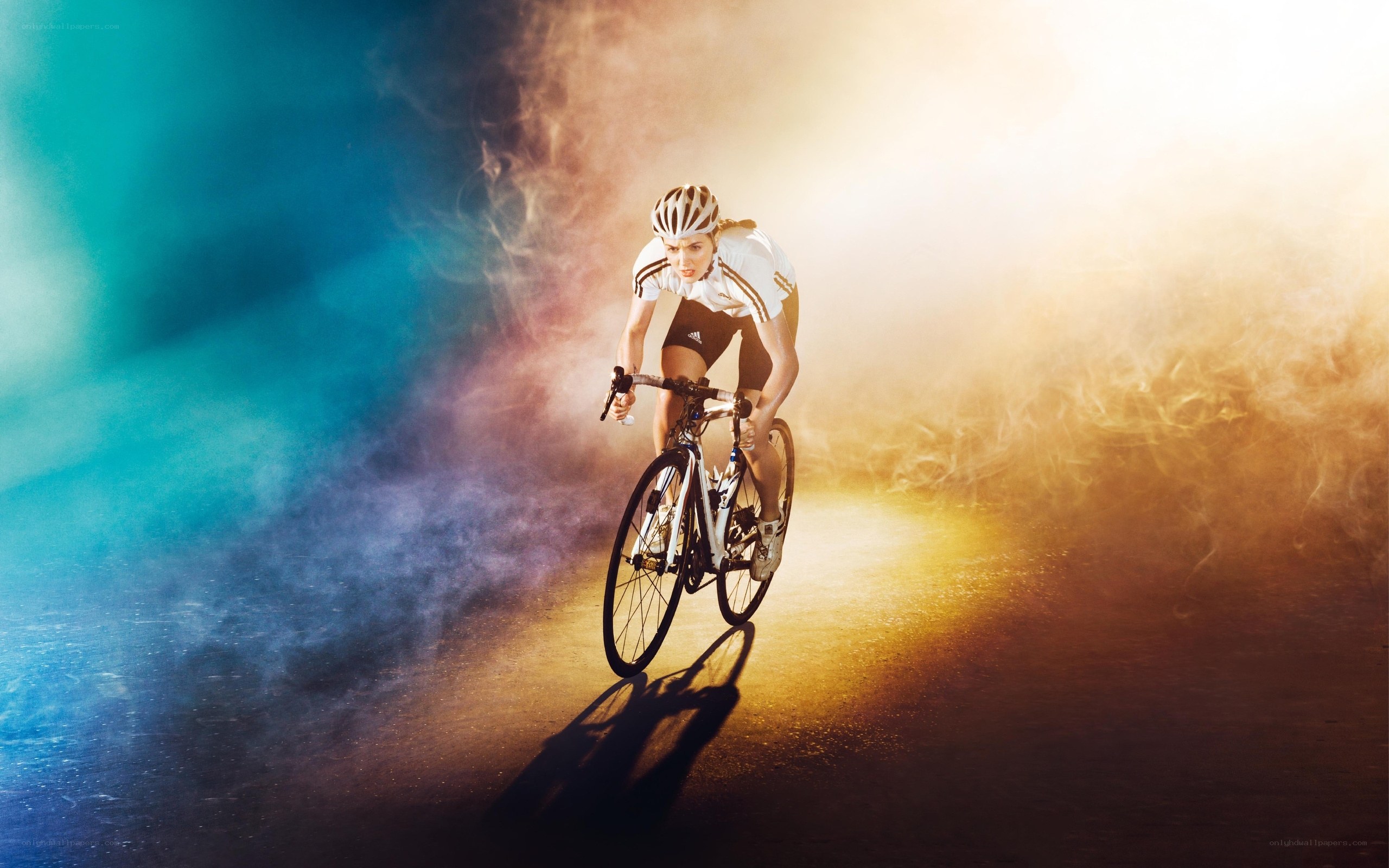 cyclist in motion with colored smoke