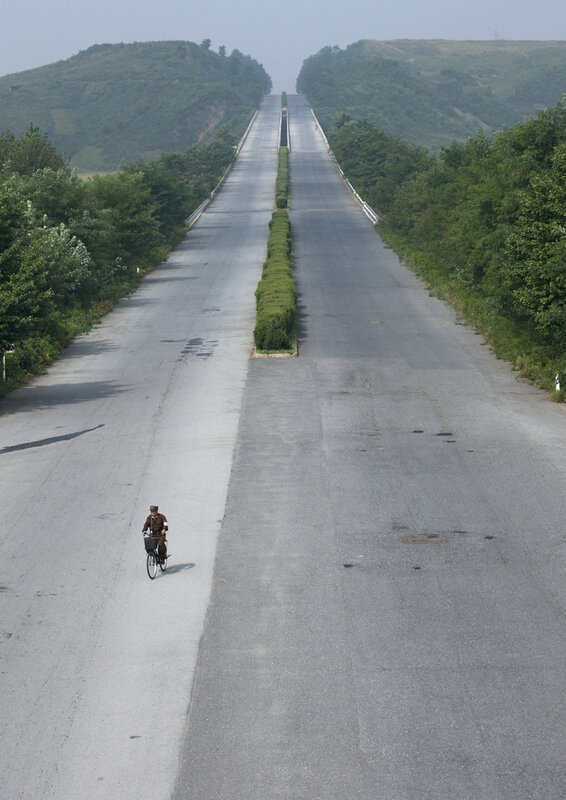 Cyclist on a long road