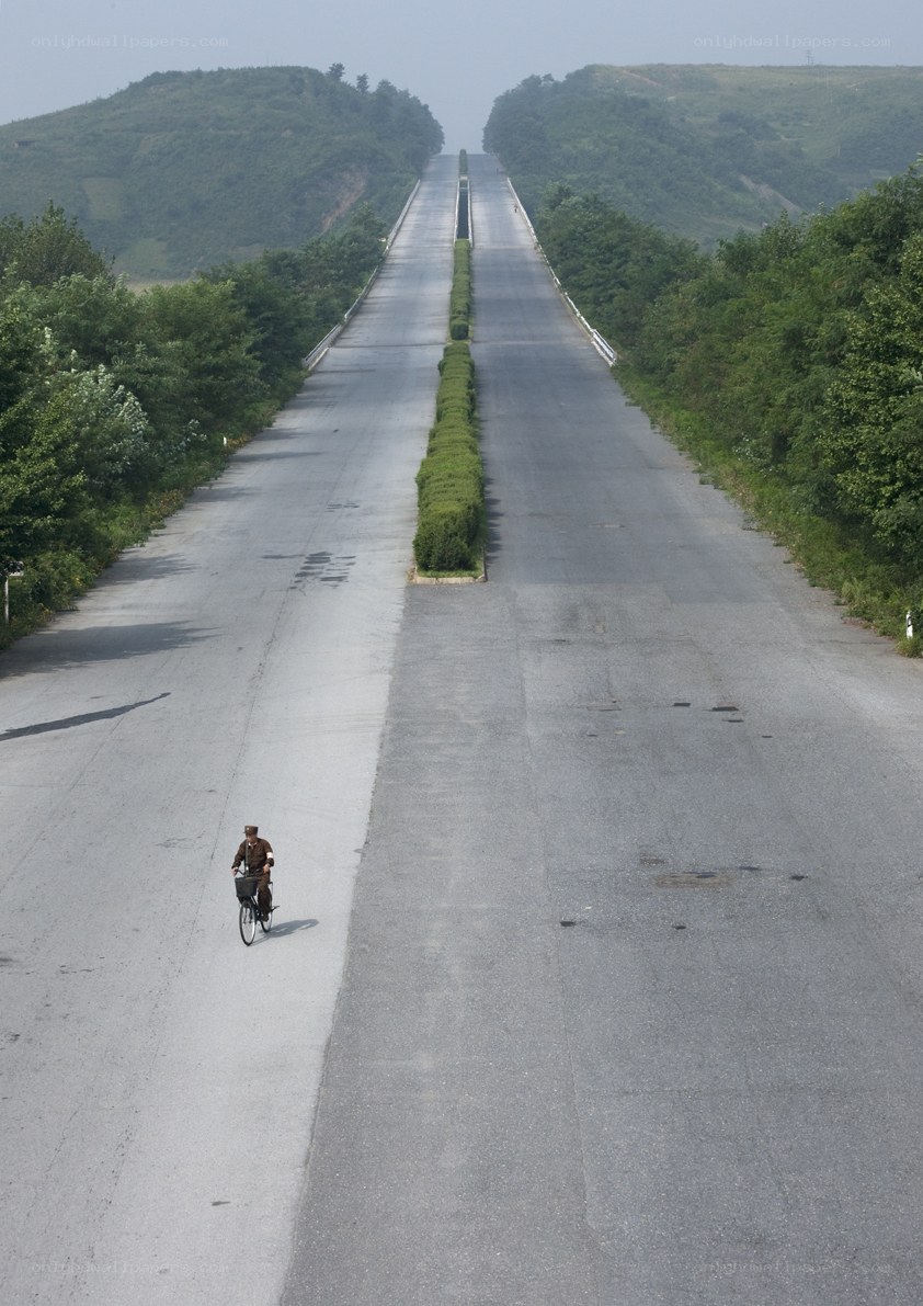 Cyclist on a long road