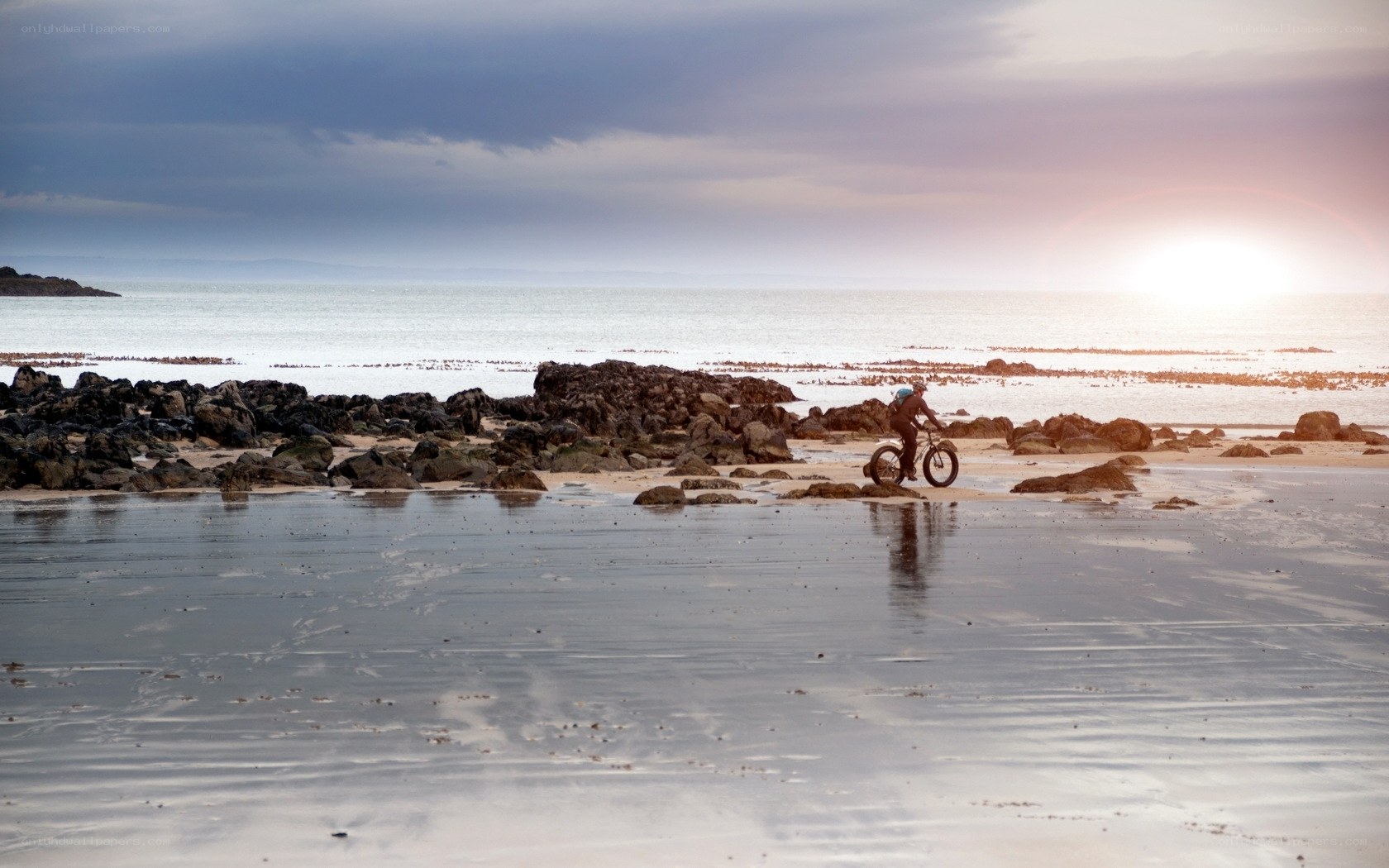 Cyclist on a rocky beach