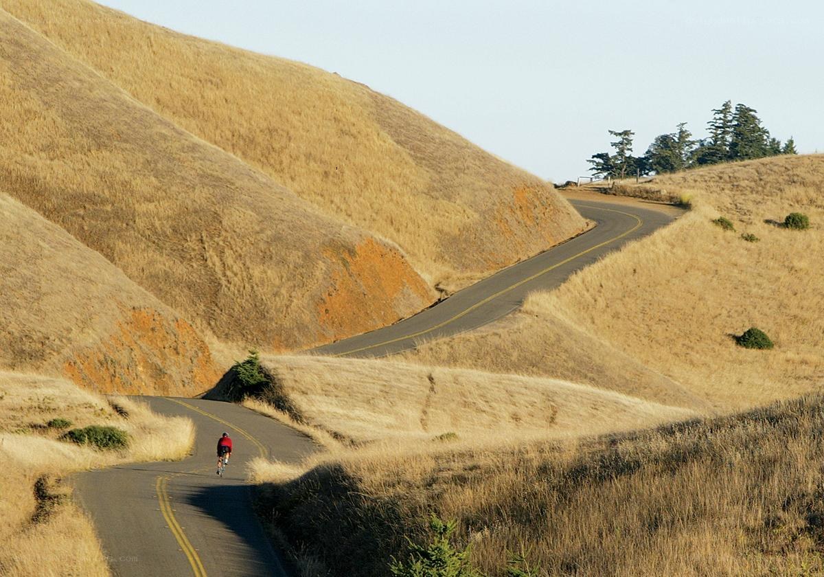 Cyclist on a winding road