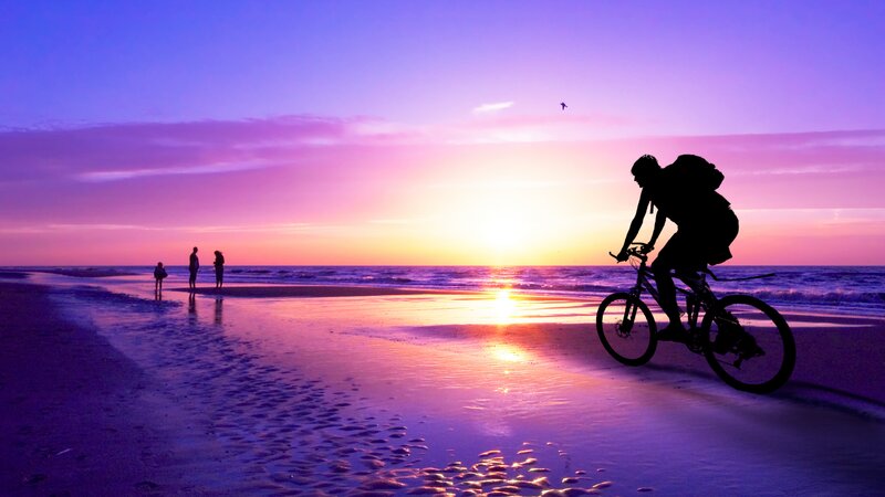 Cyclist on Beach at Sunset