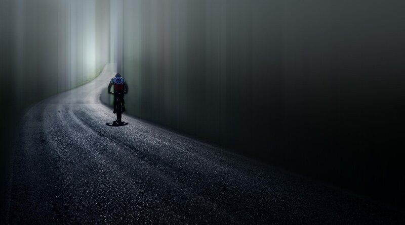 Cyclist on Dark Road