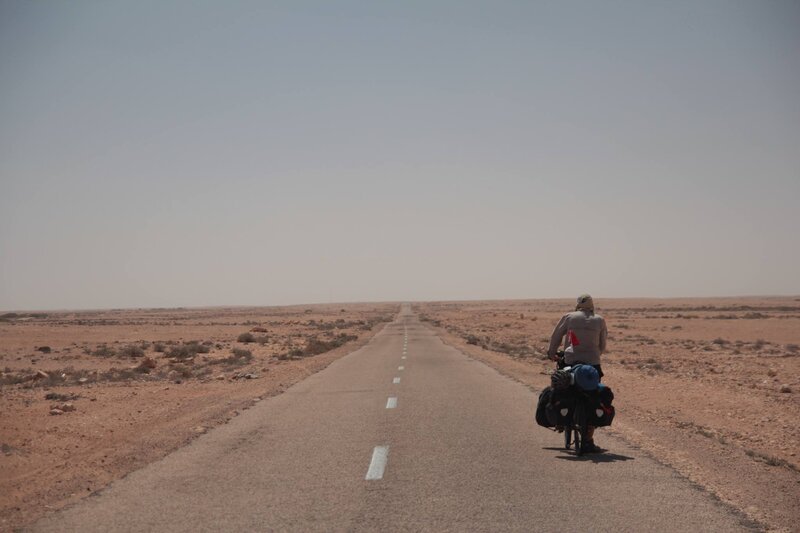 Cyclist on Desert Road — Brown
