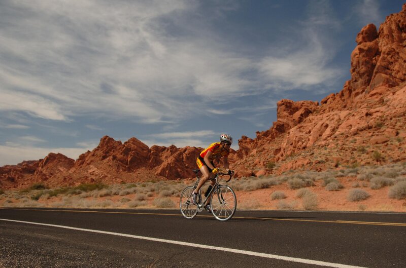 Cyclist on Desert Road — Red