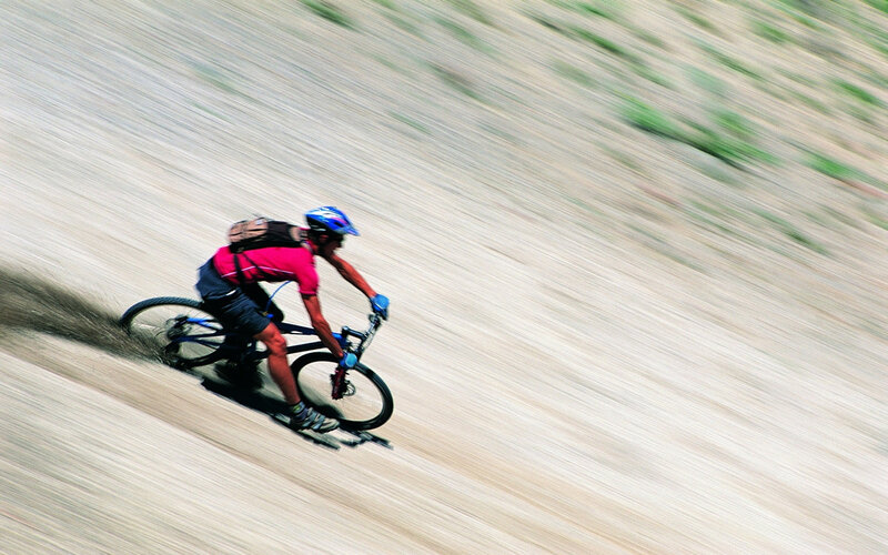 Cyclist on Dirt Path — Brown