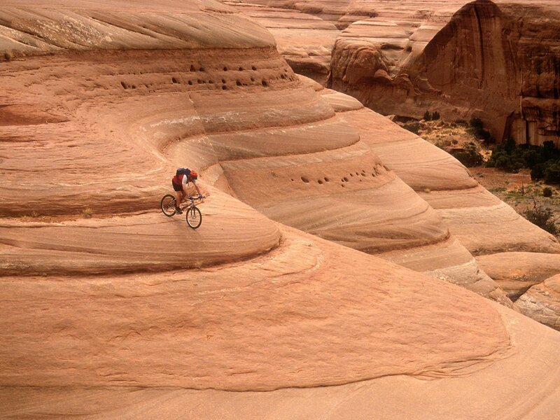 Cyclist on Rock Formation — Brown