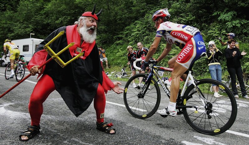Cyclist passes devil character