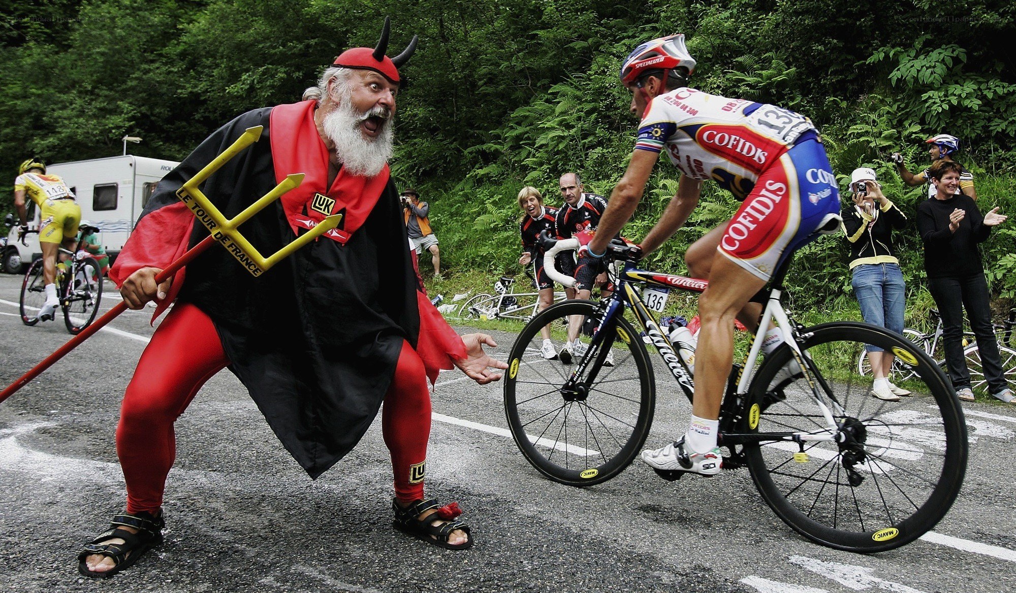 Cyclist passes devil character