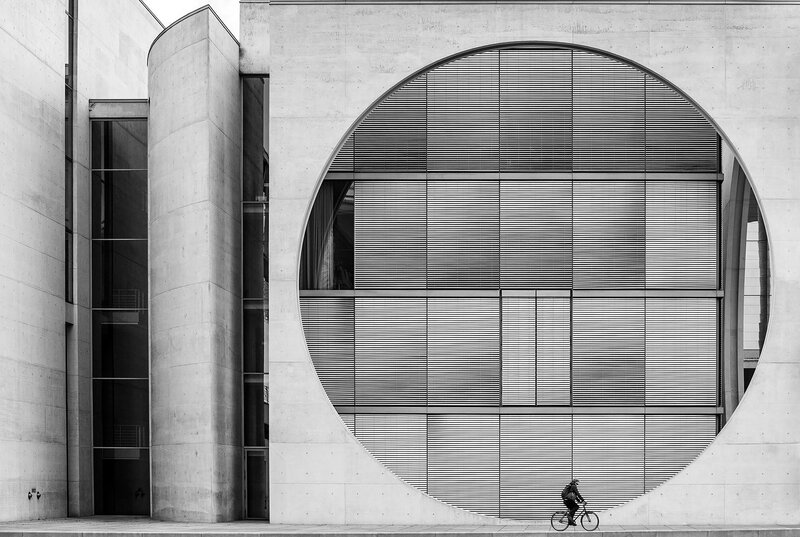 Cyclist Passing Building