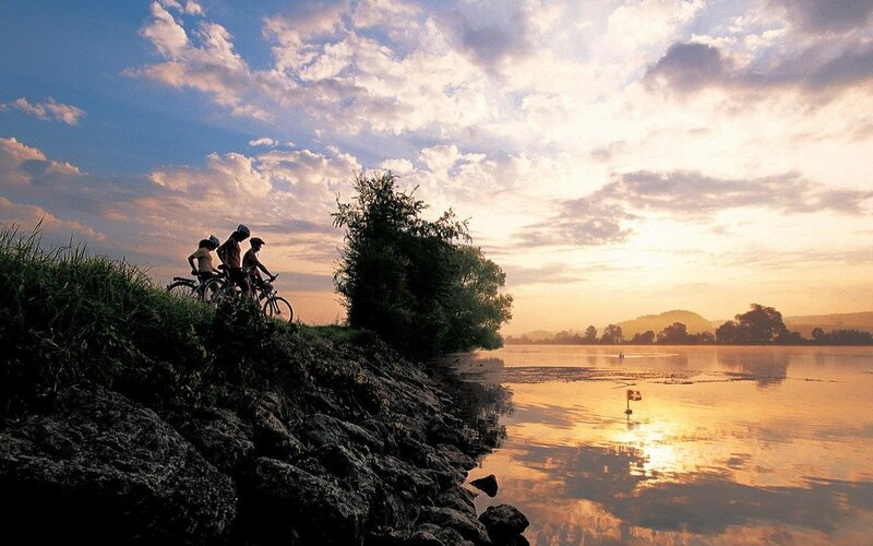 Cyclists at sunset by the lake