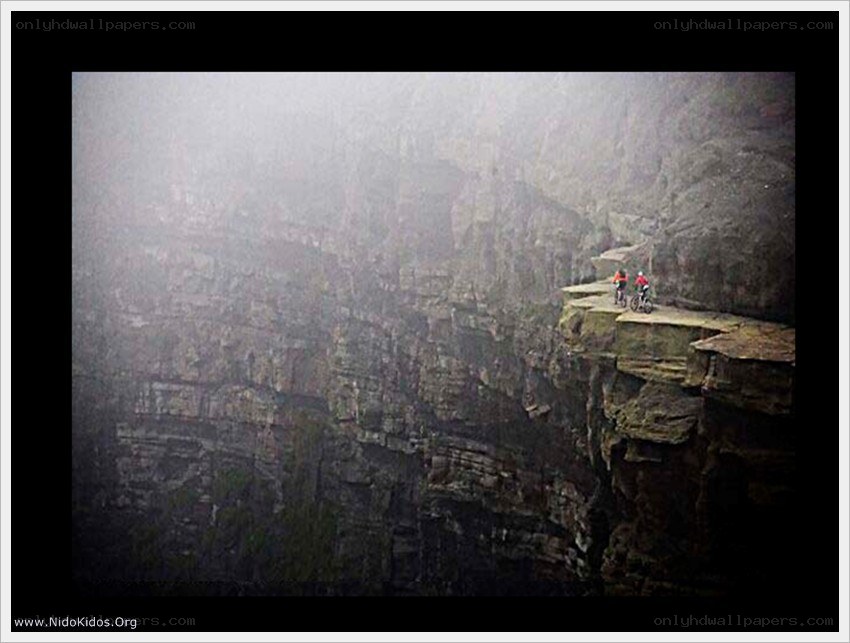 Cyclists on a cliff edge