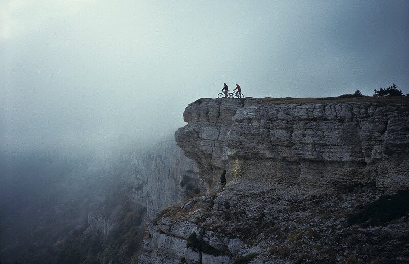 Cyclists on a cliff edge