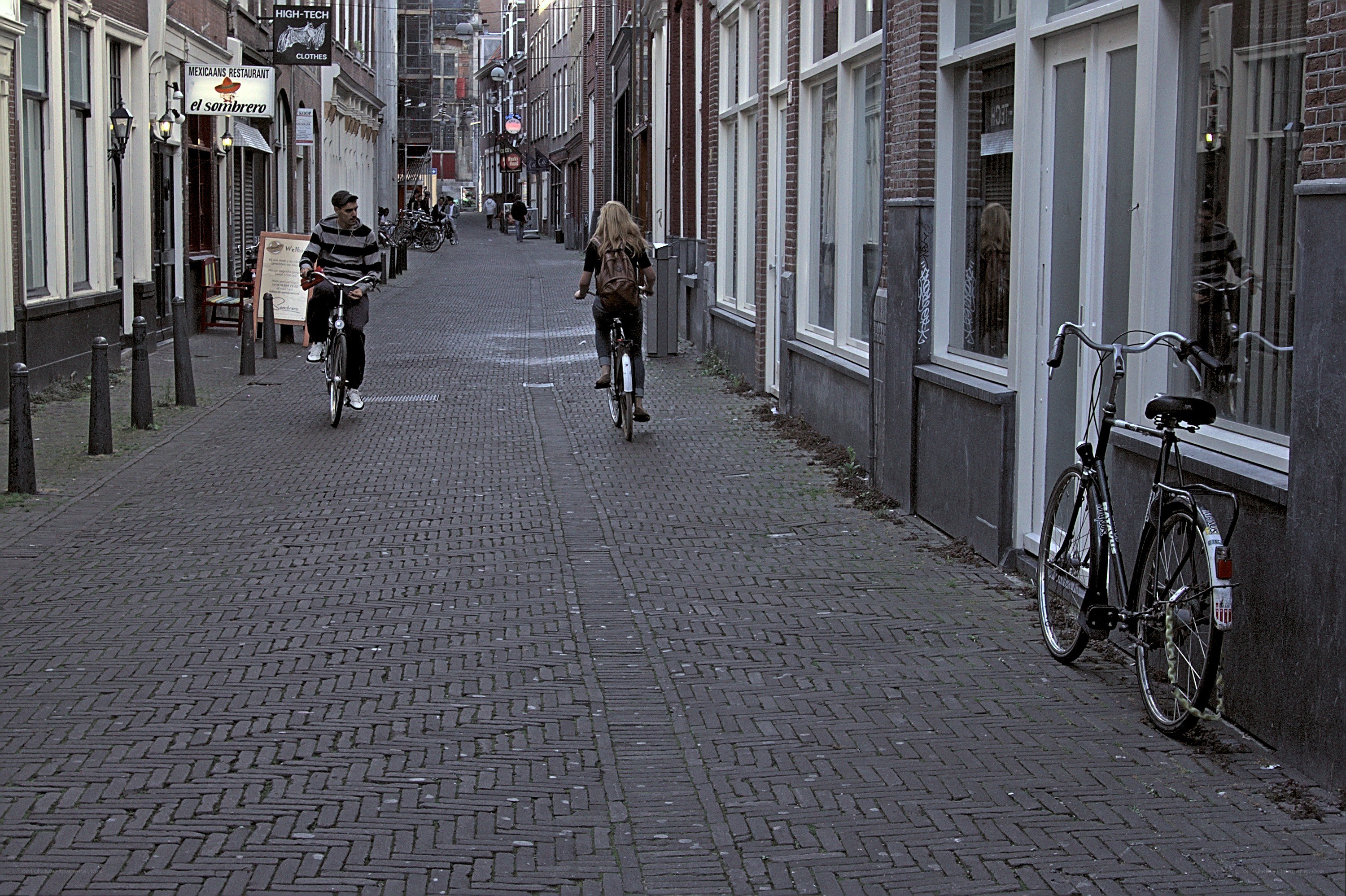 Cyclists on a cobblestone street