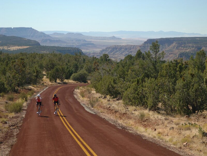Cyclists on a red road