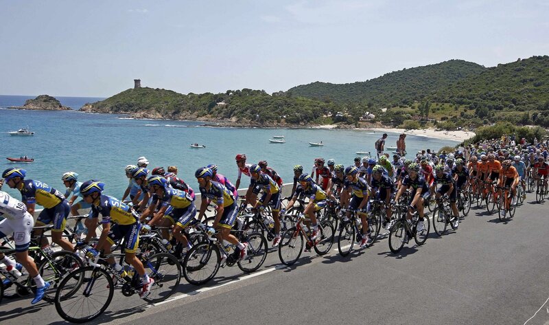 Cyclists racing along the coast