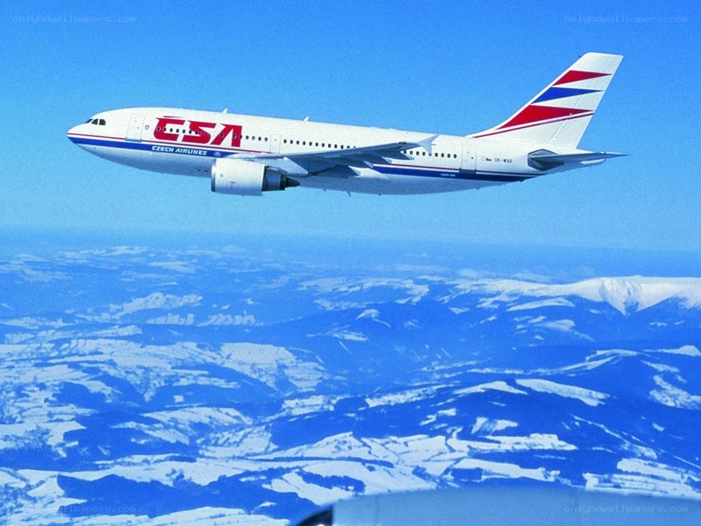 Czech Airlines plane flying over mountains