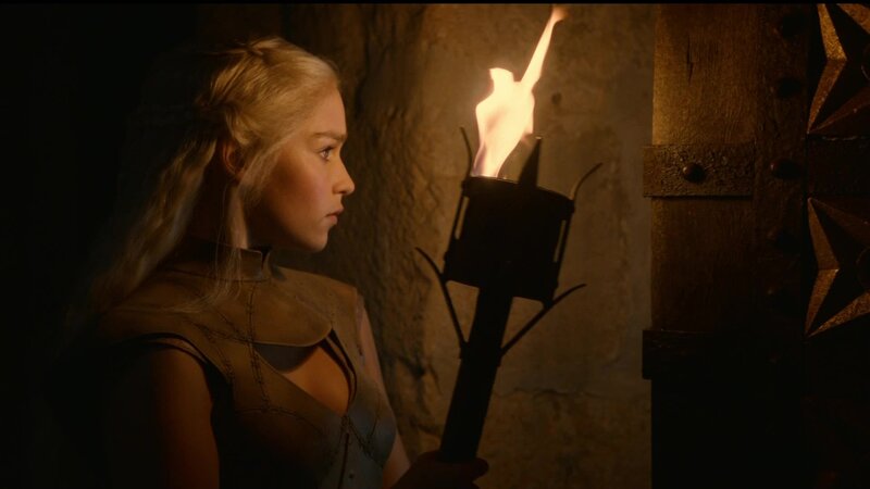 Daenerys in a torchlit corridor