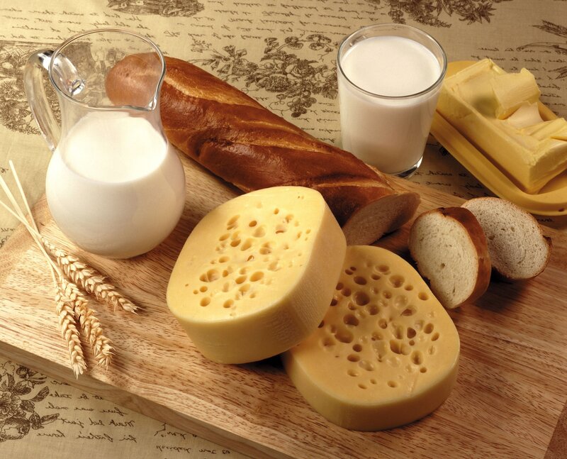 dairy and bread on wooden board