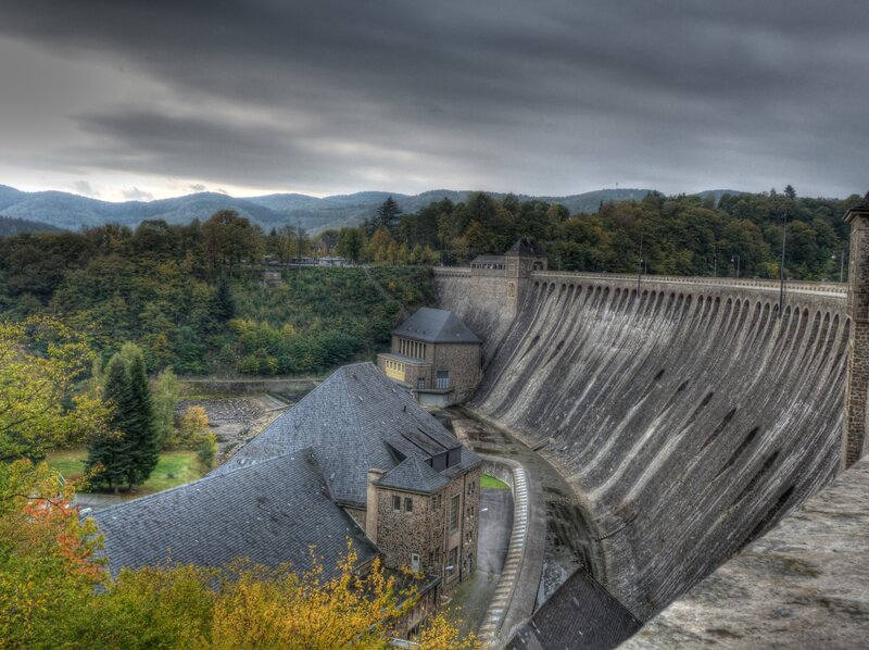 Dam and buildings in a forested valley