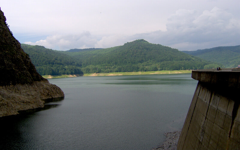 Dam and reservoir in forested valley