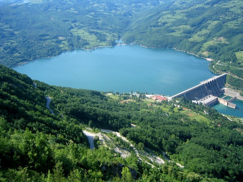 Dam and reservoir in green valley