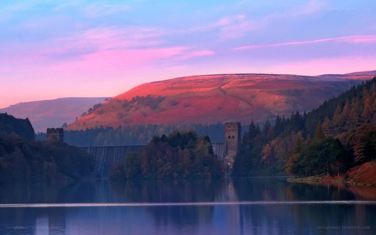 Dam at sunset with hills