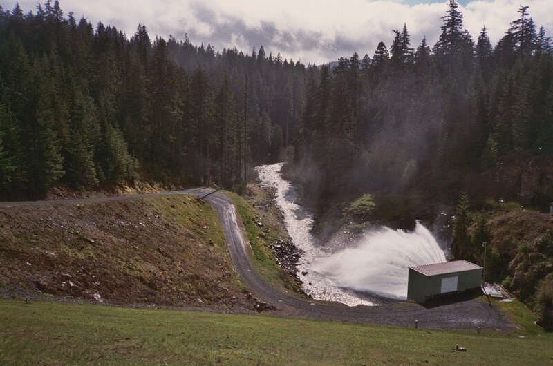 Dam spillway in forested valley