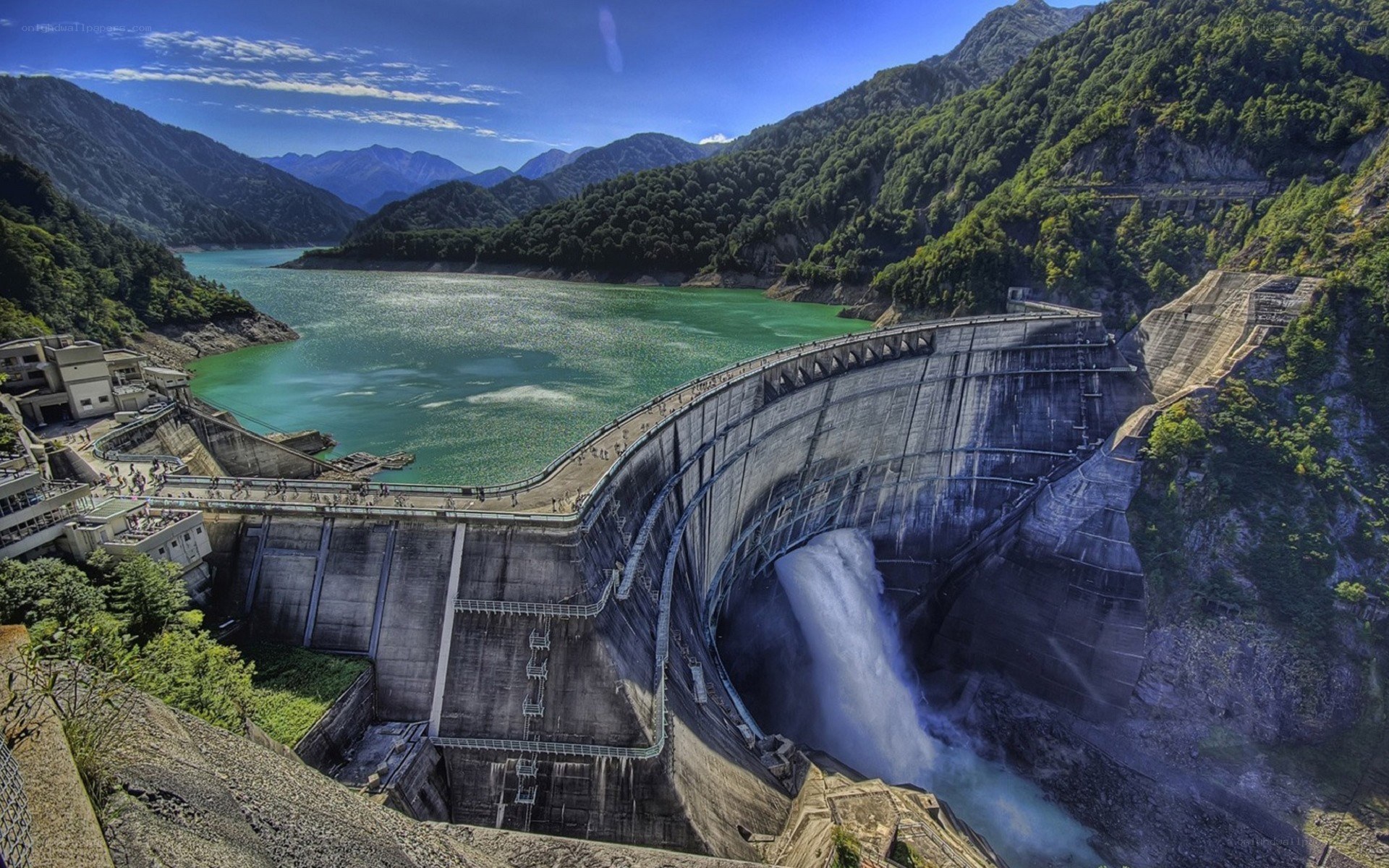Dam with water release in mountain valley