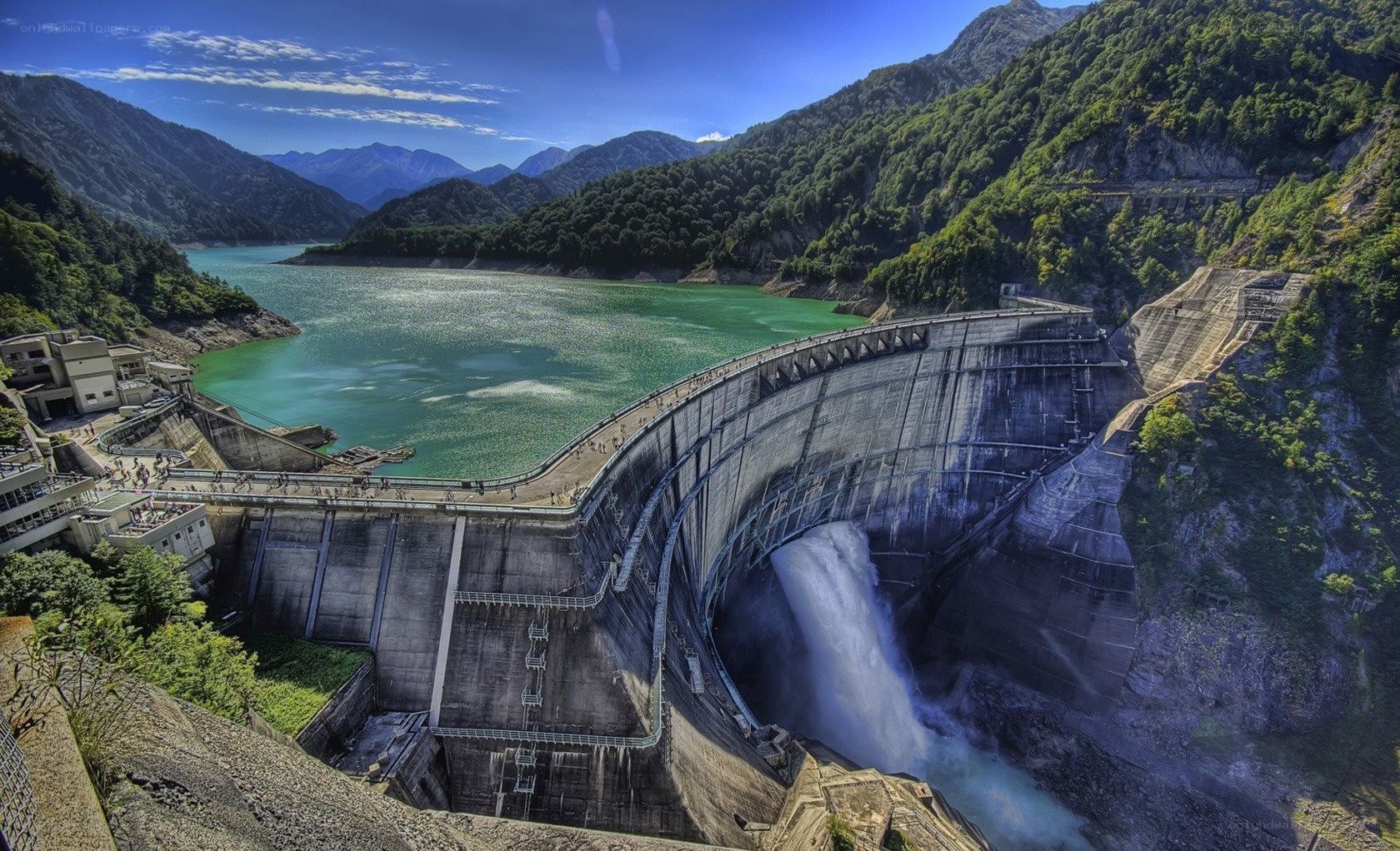 Dam with waterfall in mountain valley